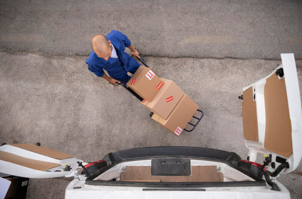 a courier carries boxes on a cart