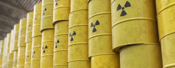 Yellow radioactive material containers stand stacked, ready for transport from NSW to VIC - iStock