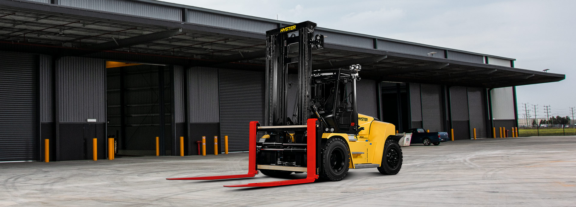 A Hyster forklift in Australia standing on pavement outdoors.